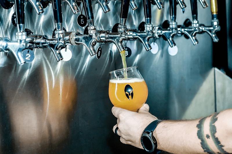 Pouring beer from a tap into a glass.