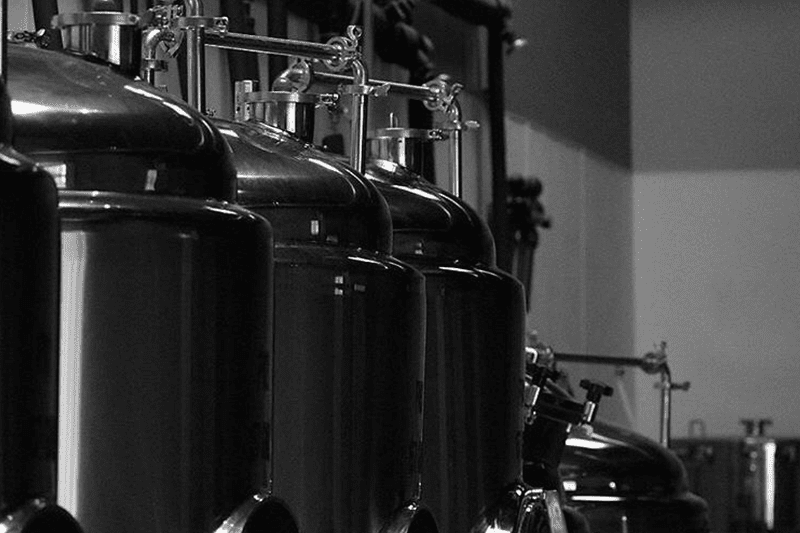 Black and white photo of industrial vats.